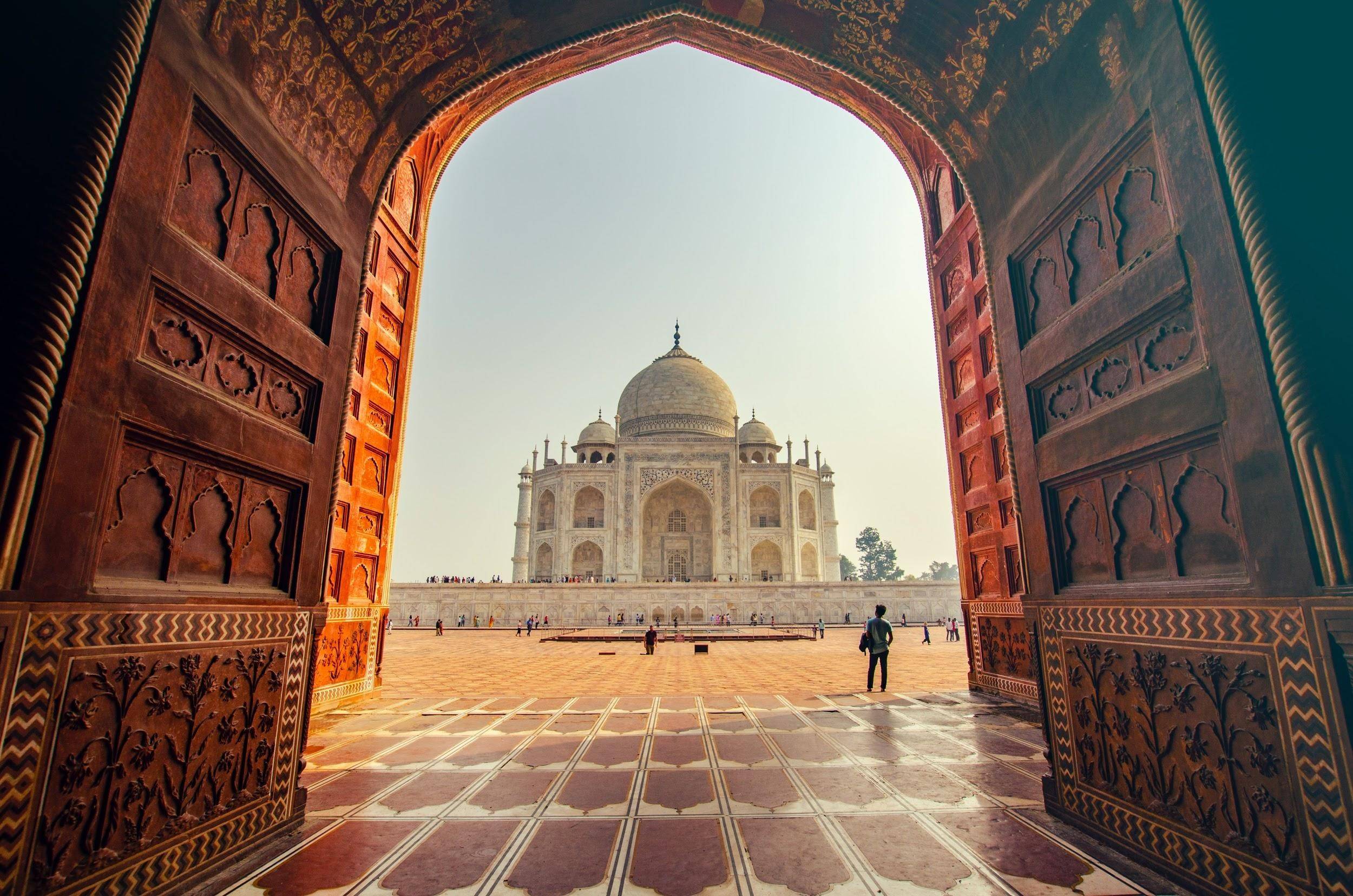 Are you looking to visit India this year for ICC CWC 2021? A view of Taj Mahal India from front borwn colored gate