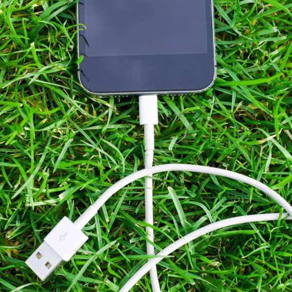 The 5 Best "Dumbphones" That Are Actually Smart iPhone laying in grass