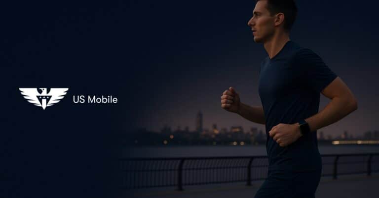 A runner on a riverside path at dusk wearing a smartwatch and carrying no phone, with the us mobile logo on the left