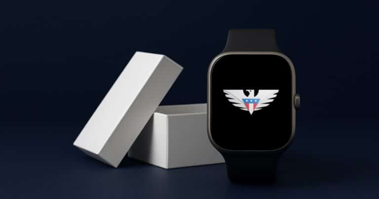 A smartwatch with the us mobile eagle on its screen standing in front of its opened white box